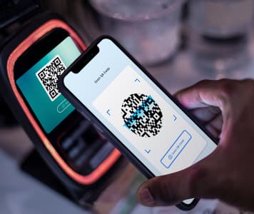 scans the barcode with a mobile phone